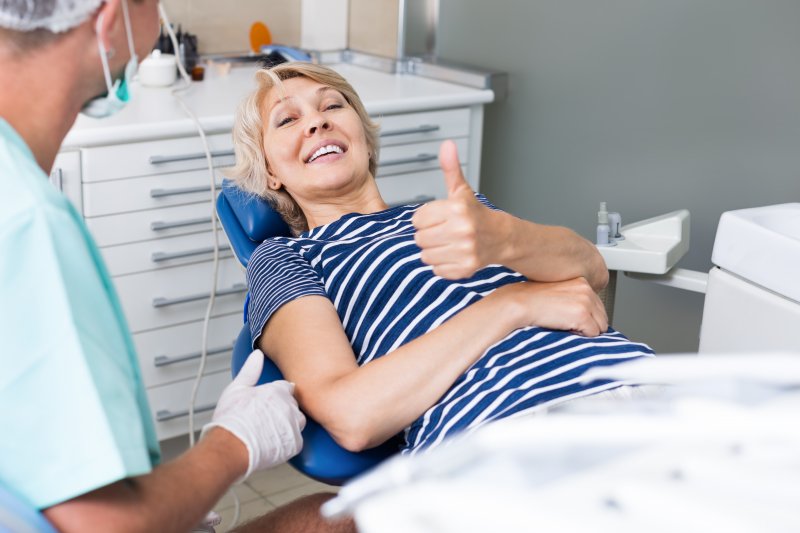 Woman smiling during her implant consultation