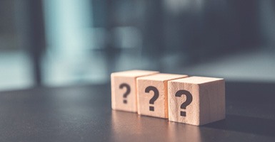 Three wooden blocks with question marks on them