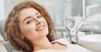 Female dental patient lying back in chair