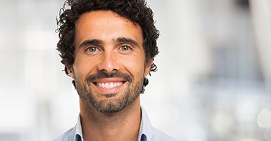 Bearded man standing up and smiling