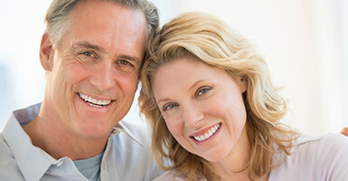 Older couple holding each other while smiling