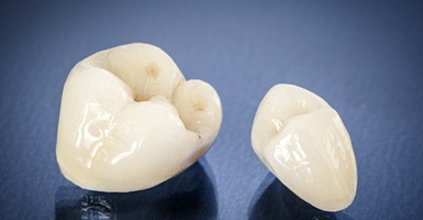 Two white dental crowns on a black background