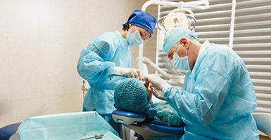 Oral surgeon and assistant placing dental implants in Odessa, TX