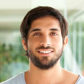 Young man with facial hair smiling
