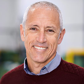 Male in a maroon sweater smiling