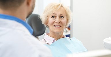 Senior woman learning about her candidacy for implant dentures