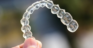 Close-up of hand holding Invisalign in Odessa, TX
