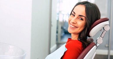 Smiling dental patient in red shirt