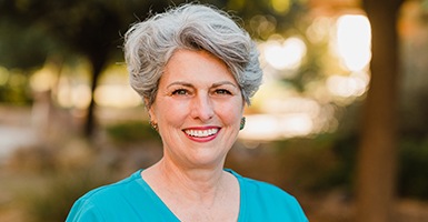 Woman with a blue shirt on smiling