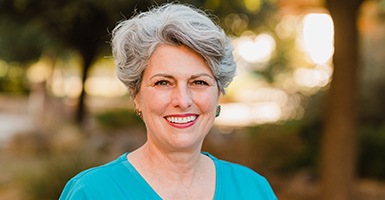 Woman with a blue shirt on smiling 