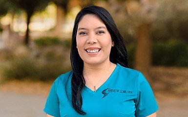 Woman with a blue shirt on smiling 