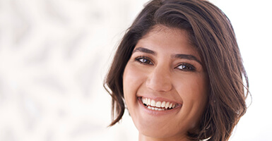 Woman with short hair showing her pearly whites