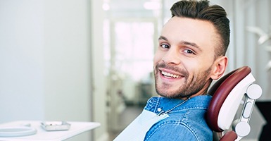 Man with veneers in Odessa smiling in dentist’s chair