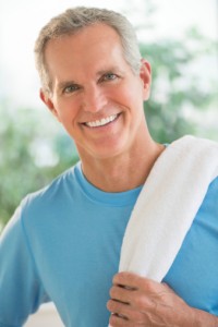 smiling man with towel on shoulder