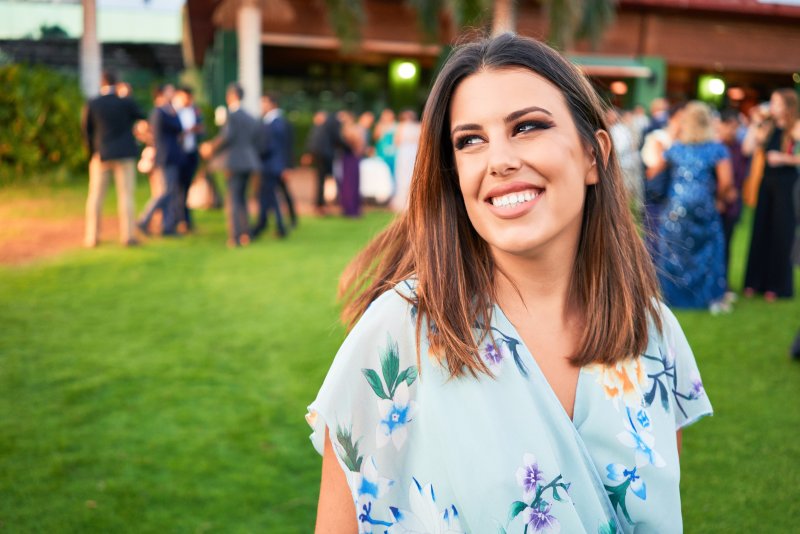 Woman with white teeth smiling at an event