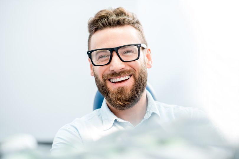 man smiling while visiting in dentist in Odessa