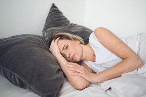 Woman lying in bed after having a bad dream